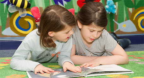 Two children reading a book