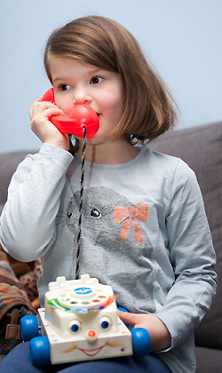 A child with a toy telephone